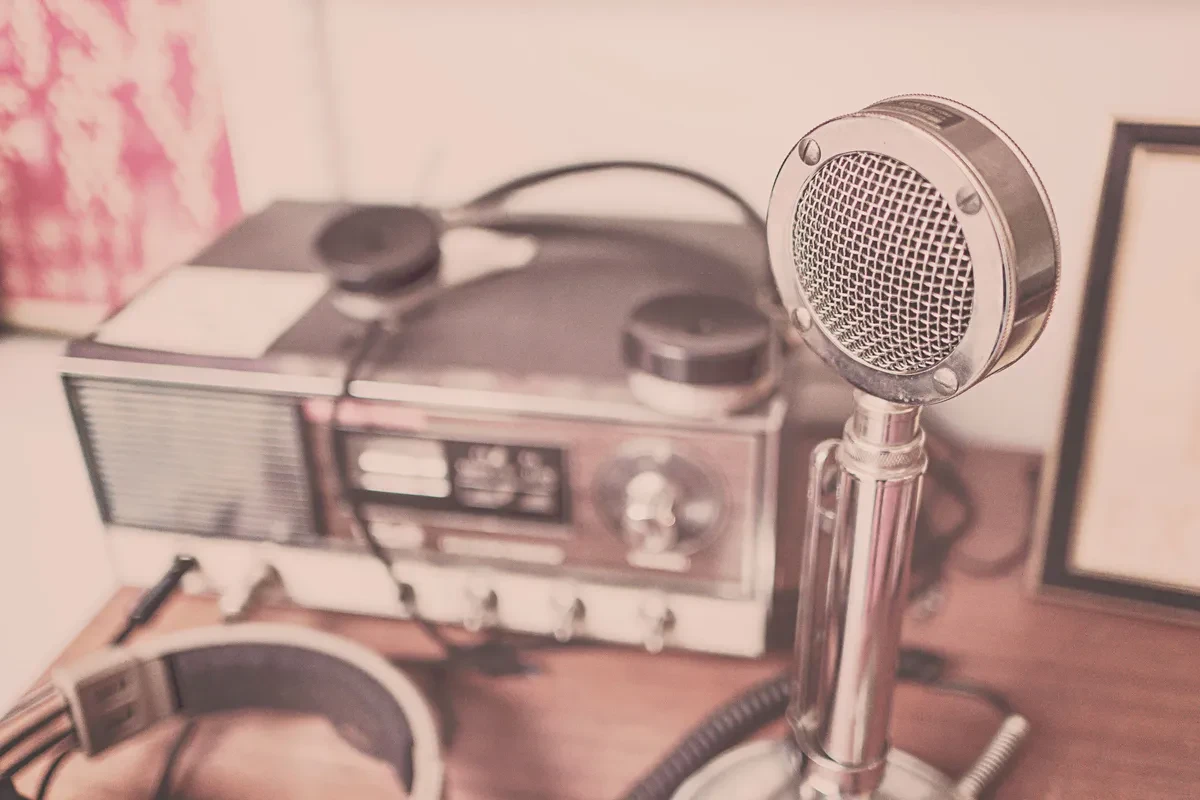 A simple ham radio setup on a desk inside an off-grid cabin, ready for emergency communication when the grid is down