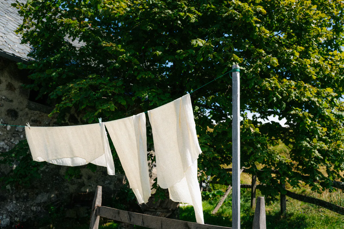 Clothes drying on an outdoor line in open countryside, the way wash day ends at an off-grid homestead