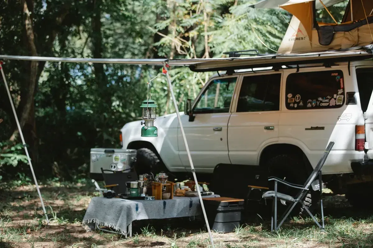 Portable power station charging phones and lights at an off-grid base camp